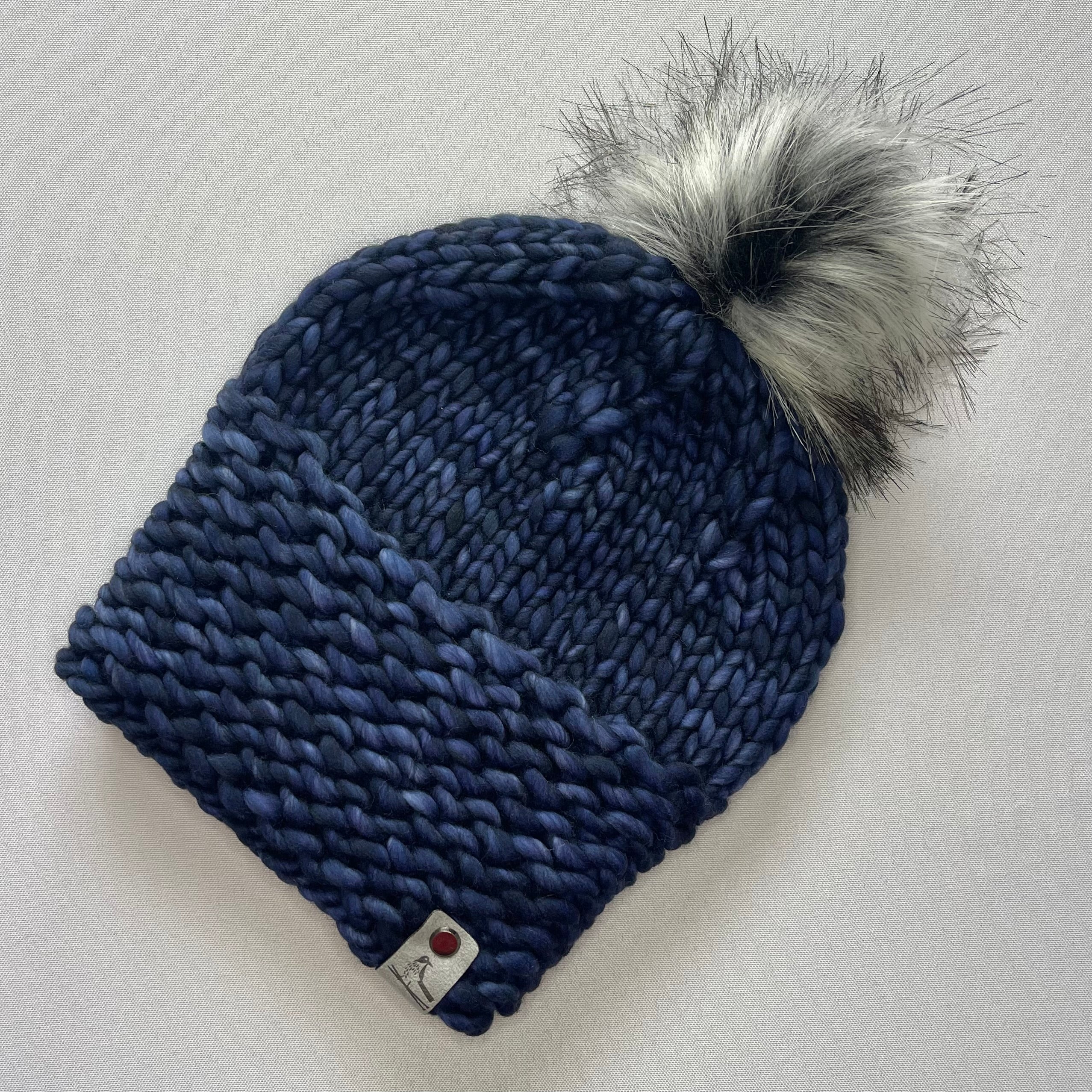 Buy Merino wool hat with faux fur Pom